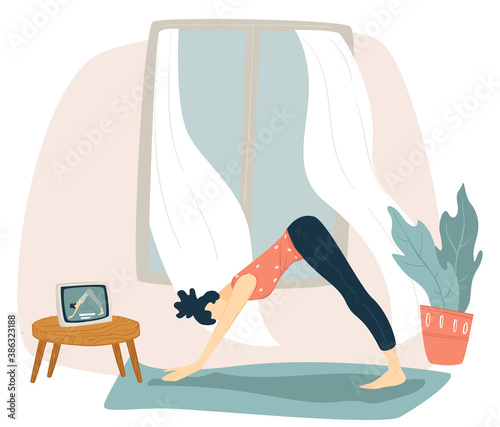 Woman doing yoga and watching tutorials at home