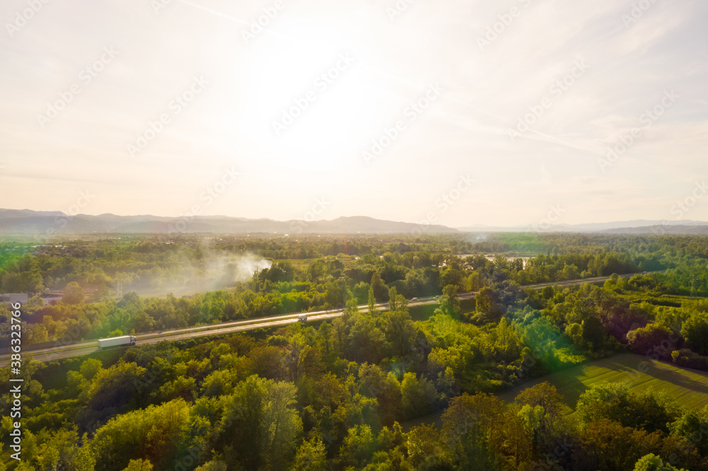 Aerial view of road crossing forest during scenic sunset, Zagreb, Croatia.