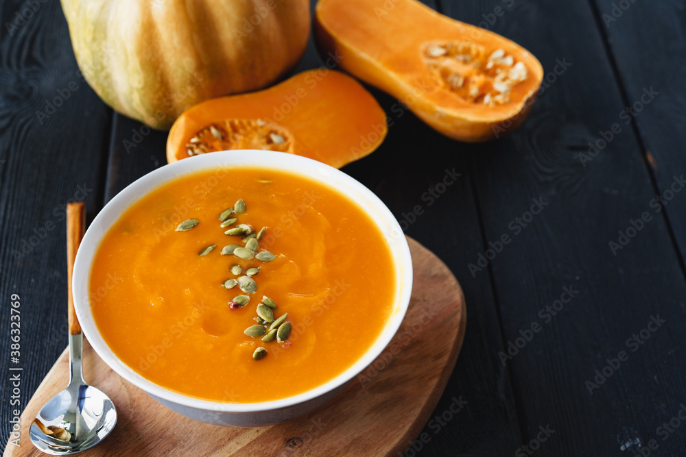 Homemade pumpkin soup on a black table Homemade pumpkin soup on a black table