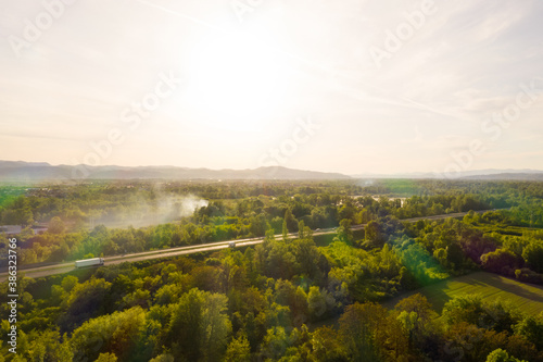 Aerial view of road crossing forest during scenic sunset, Zagreb, Croatia. © Felipe Trentini