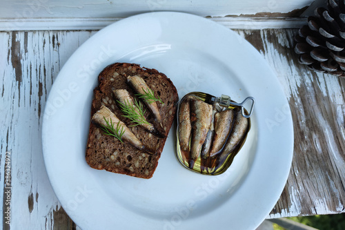 smoked sprats. black bread sandwich with sprats