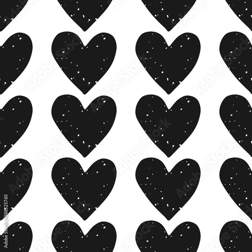 Valentine's Day block print seamless pattern with rows of grunge textured black hearts on white background
