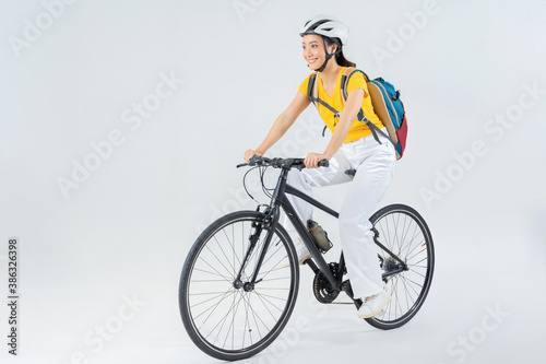 Asian beautiful woman, she is riding a city bike to work.