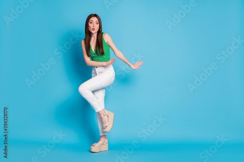 Full size photo of dream dreamy girl dance discotheque send air kiss wear style stylish trendy white singlet isolated over blue color background © deagreez