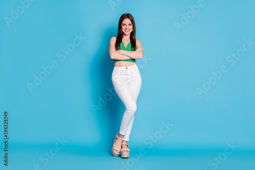 Full size photo of independent successful worker girl cross hands enjoy business travel trip walk solution wear singlet isolated over blue color background