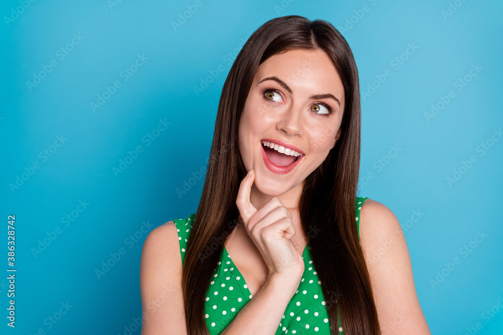 Closeup photo of attractive pretty lady hold arm on chin intelligent creative clever interested look side up empty space wear green dotted tank-top singlet isolated blue color background Closeup photo of attractive pretty lady hold arm on chin intelligent creative clever interested look side up empty space wear green dotted tank-top singlet isolated blue color background