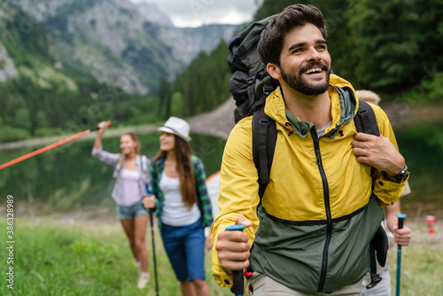 Group of happy hiker friends trekking as part of healthy lifestyle outdoors activity