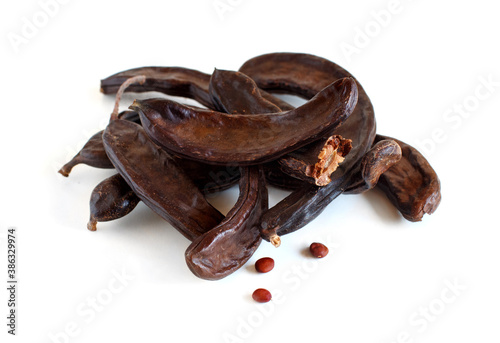 Dry carob pods and seeds close up photo