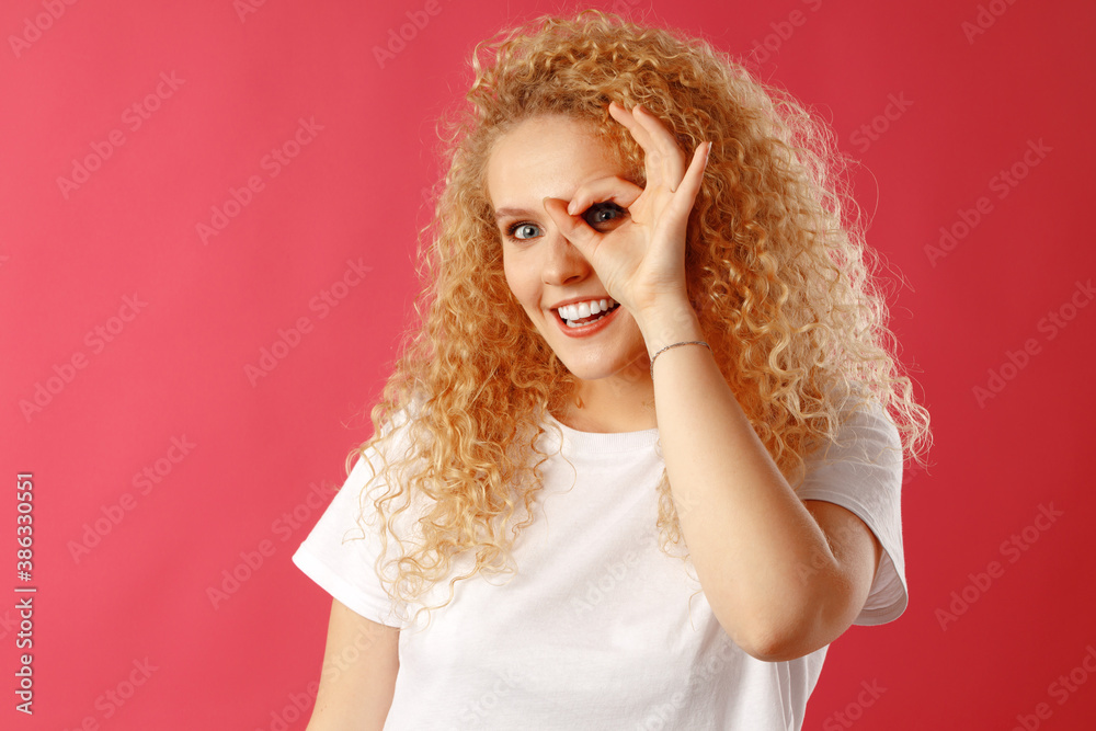 Positive friendly young woman showing OK sign