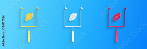Paper cut American football with goal post icon isolated on blue background. Paper art style. Vector.