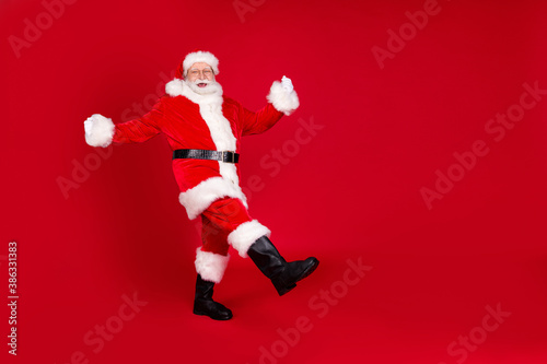 Full length body size view of his he nice attractive handsome funny cheerful cheery Santa dancing having fun grimacing isolated bright vivid shine vibrant red color background