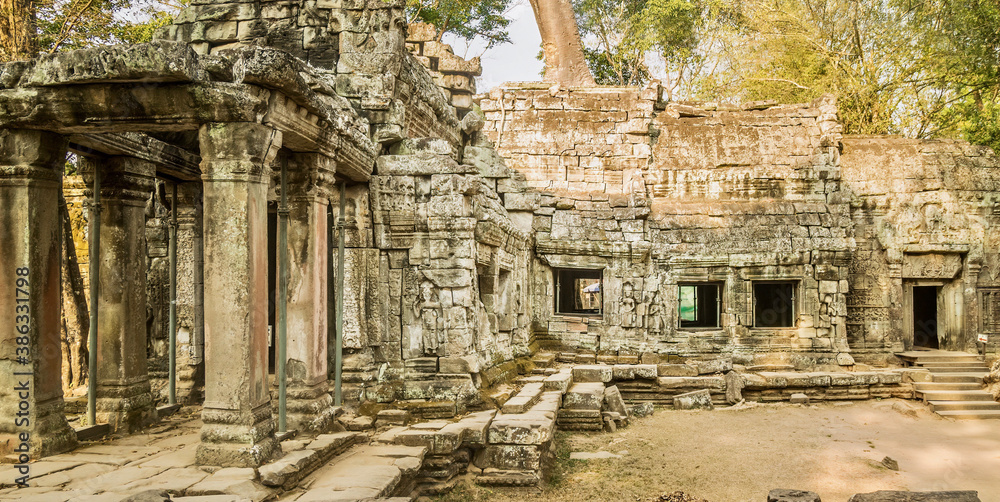 Exterior walls of Ta Prohm, known as the jungle temple, part of the 12th century Angkor Wat complex in Siem Reap, Cambodia. The deteriorating structure is being supported by metal posts.