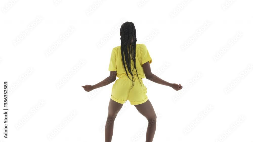 Back view of young African American woman bending knees, rolling buttocks around, doing shoulder hustle move. Twerking seductive dance. Isolated on white background. Stock ビデオ | Adobe Stock