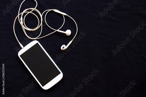 mobile phone with earphone for business work arrangement flat lay style on background white
