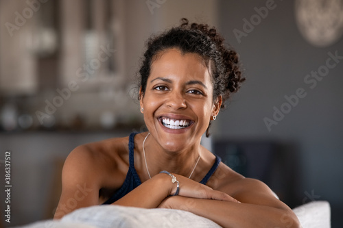фотографія Cheerful black mid adult woman smiling at home