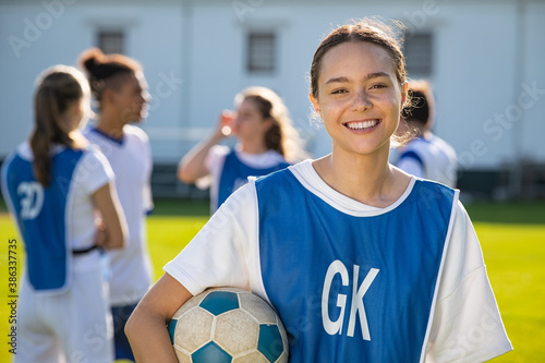 Happy smiling girl player on field