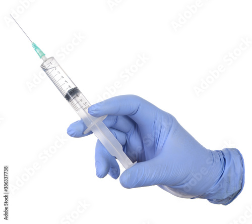 Hand in medical glove with syringe