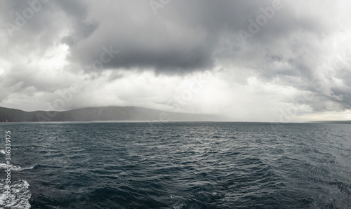 Dramatic image of agitated sea near mountain island, Croatia. photo