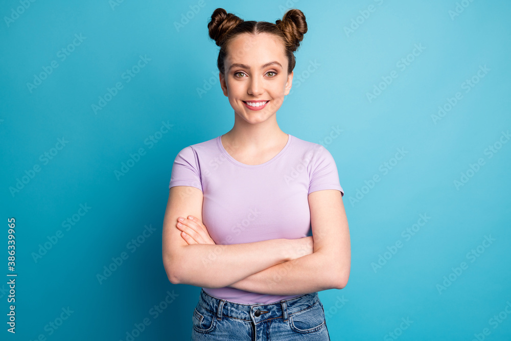 Photo of attractive teen lady two funny buns good mood toothy white smile charming nice person business freelancer arms crossed wear casual purple t-shirt isolated blue color background - obrazy, fototapety, plakaty 