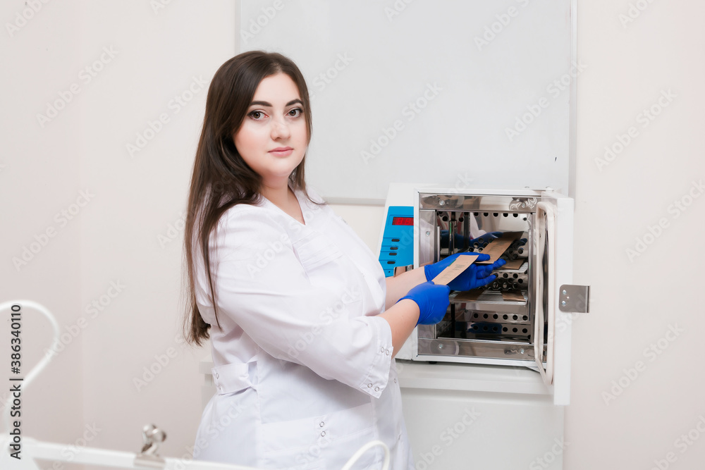 A handsome cosmetologist with long dark hair is performing an electrolysis procedure. In the beautician's office. Close-up.
A handsome cosmetologist with long dark hair is performing an electrolysis procedure. In the beautician's office. Close-up.