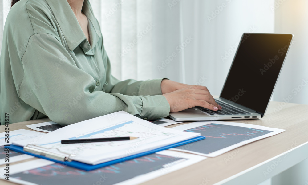 Hand of businesswoman are planning business investments related to shares By analyzing and calculating the stock market for marketing profits
