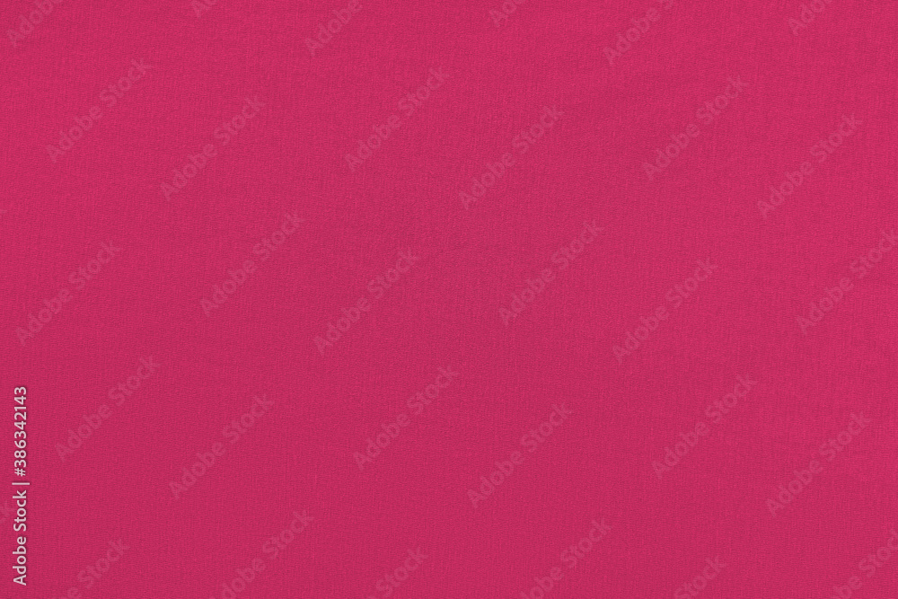 Red homogeneous background with a textured surface, fabric.