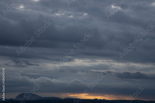 A Panoramic Silhouette of low hills in wide angle view and beautiful clouds formation in the Horizon