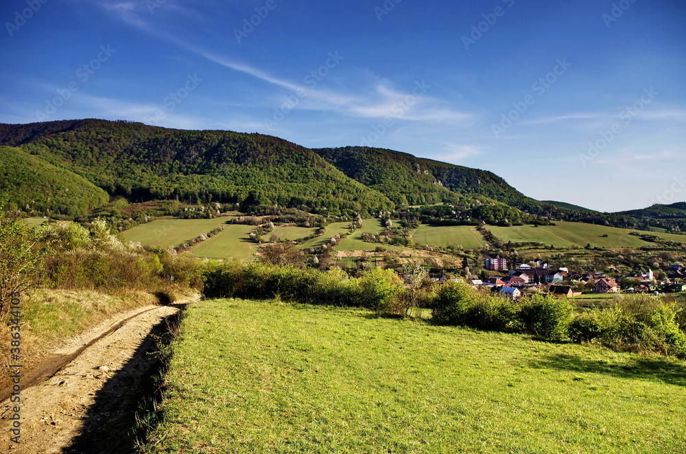 Beautiful nature landscape panorama.Green Meadow with blue sky and Village In Summer, Slovakia. Traveling, agriculture and hiking concept.