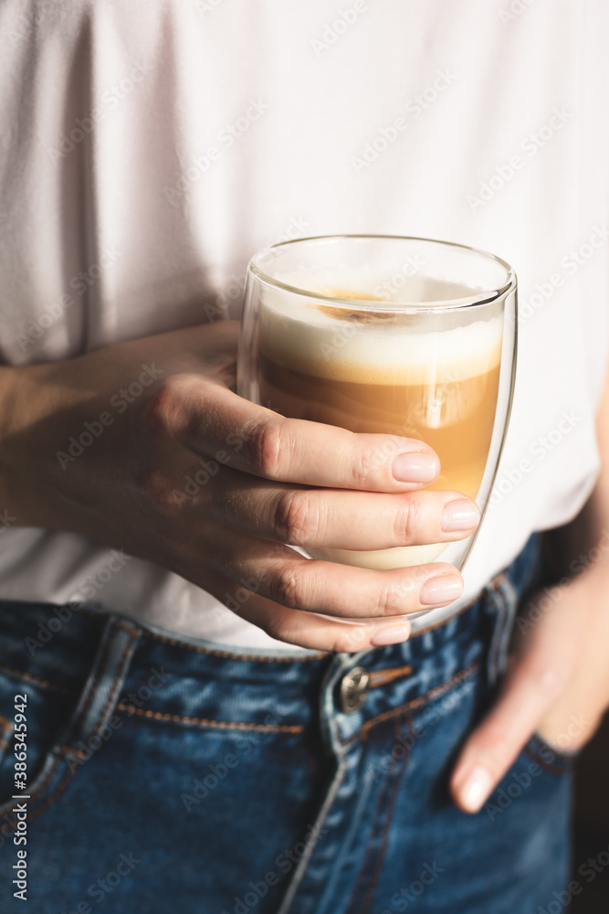 Woman holding a cup of coffee Woman holding a cup of coffee