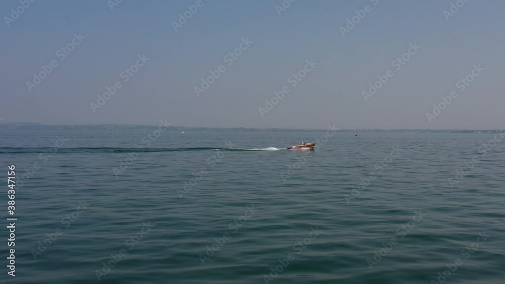 Wooden boat with a motor movement on the water panoramic view from the side. People in boat aerial view Wooden boat with a motor movement on the water panoramic view from the side. People in boat aerial view