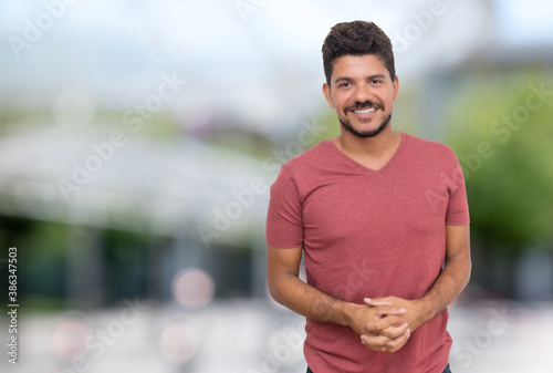 Laughing latin american man with beard