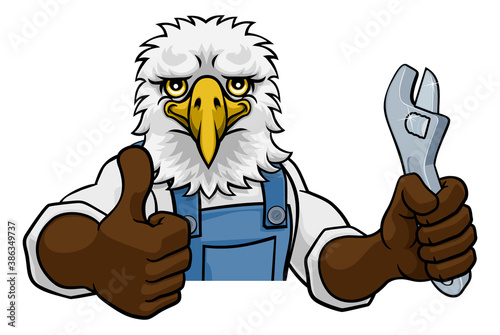 An eagle cartoon animal mascot plumber, mechanic or handyman builder construction maintenance contractor peeking around a sign holding a spanner or wrench and giving a thumbs up
