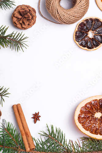 Christmas composition with dried citrus slices, cinnamon, anise, pine cones and fir tree branches, top view copy space