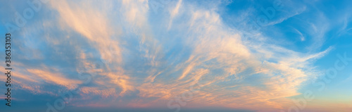 Majestic vanilla sky at evening. Azure sunset heaven with golden pink cirrus clouds over the horizon. Panoramic shot of pastel colored skyscape. Beauty in nature. photo