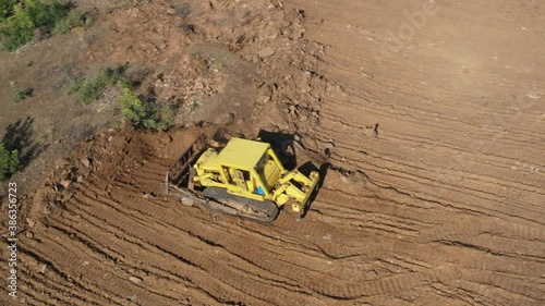 Earthworks Dozer (Bulldozer) Excavator in mountainous terrain, land correction and field clearing