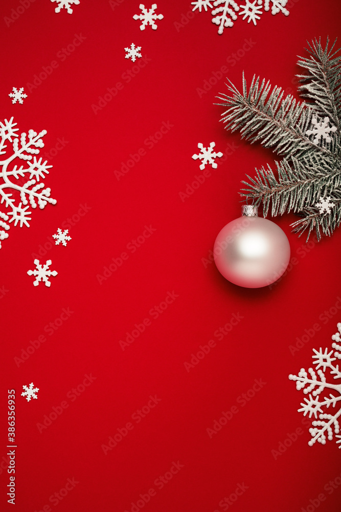Christmas background with fir tree twig, white Christmas ball and snowflakes on red copy space. Christmas background with fir tree twig, white Christmas ball and snowflakes on red copy space.