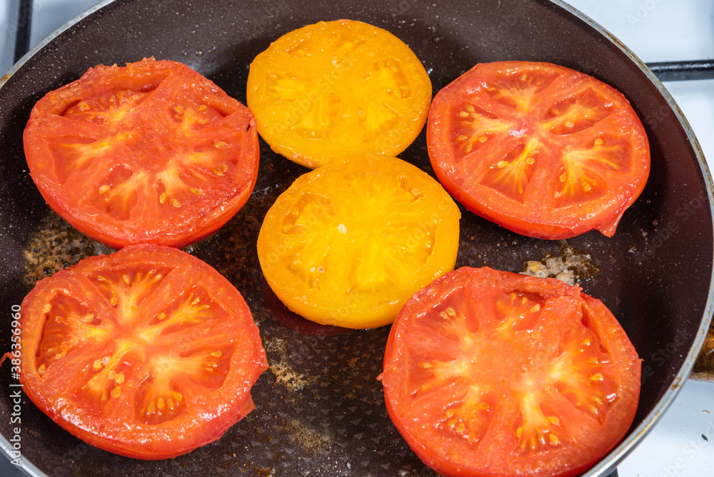 Provencal tomato - tomato halves are fried in butter in a pan