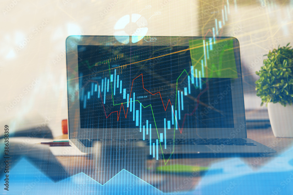 Forex market chart hologram and personal computer background. Double exposure. Concept of investment. Forex market chart hologram and personal computer background. Double exposure. Concept of investment.