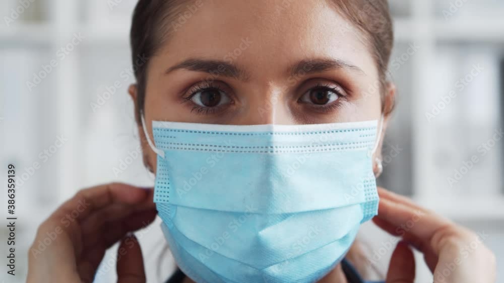 Professional medical doctor in hospital office, Portrait of young and attractive female physician in protective mask. Professional medical doctor in hospital office, Portrait of young and attractive female physician in protective mask.