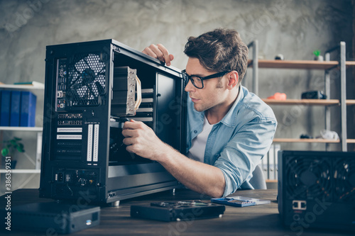 Close-up portrait of his he serious nice attractive focused guy geek skilled technician repairing hardware detail change testing at modern loft industrial home office work place station photo