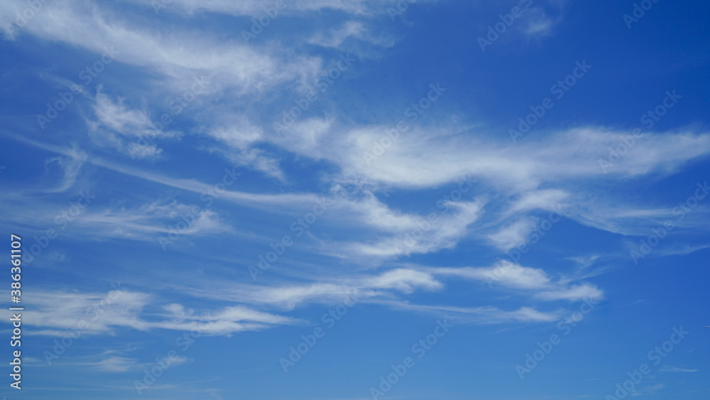Blue sky with wispy white clouds on a windy day.