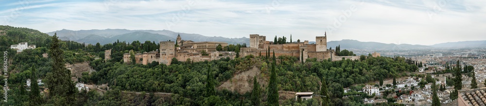 Panoramic shot of Alhambra Palace from Albacin point of view Granada, Andalucia, Spain - September 2020. Cloudy autmn day.