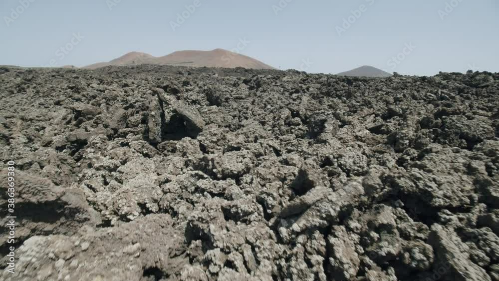 Point of view shot of an explorer making his way climbing lava rocks. Lifeless and barren terrain of Lanzarote, Canary Island. Unique nature Point of view shot of an explorer making his way climbing lava rocks. Lifeless and barren terrain of Lanzarote, Canary Island. Unique nature