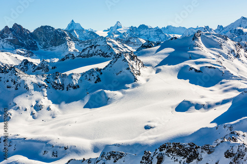 Ski in winter season, mountains and ski touring backcountry equipments on the top of snowy mountains in sunny day, Verbier Switzerland.