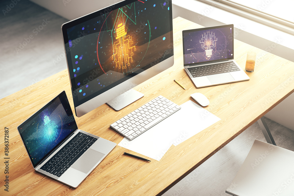 Modern computer monitor with creative light bulb hologram and chip on laptop background, idea and brainstorming concept. 3D Rendering Modern computer monitor with creative light bulb hologram and chip on laptop background, idea and brainstorming concept. 3D Rendering