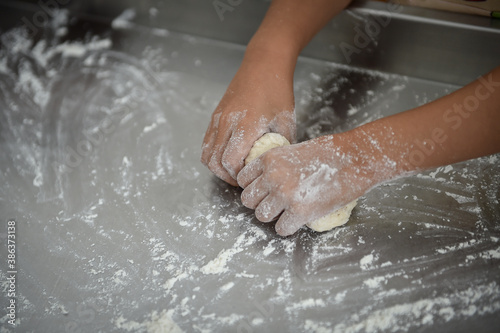 Kids playing with dough making homemade pastry products