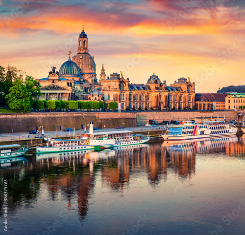 Majestic morning view of Cathedral of the Holy Trinity or Hofkirche, Bruehl's Terrace or The Balcony of Europe. Amazing spring sunrise on Elbe river in Dresden, Saxony, Germany, Europe.