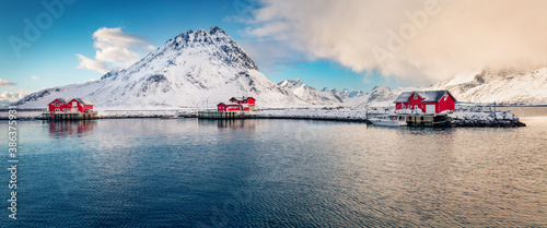 Panoramic winter view of small fishing village - Ramberg, Lofoten Islands, Norway, Europe. Attractive morning seascape of Norwegian sea, Rambergsvika fjord. Life over polar circle..