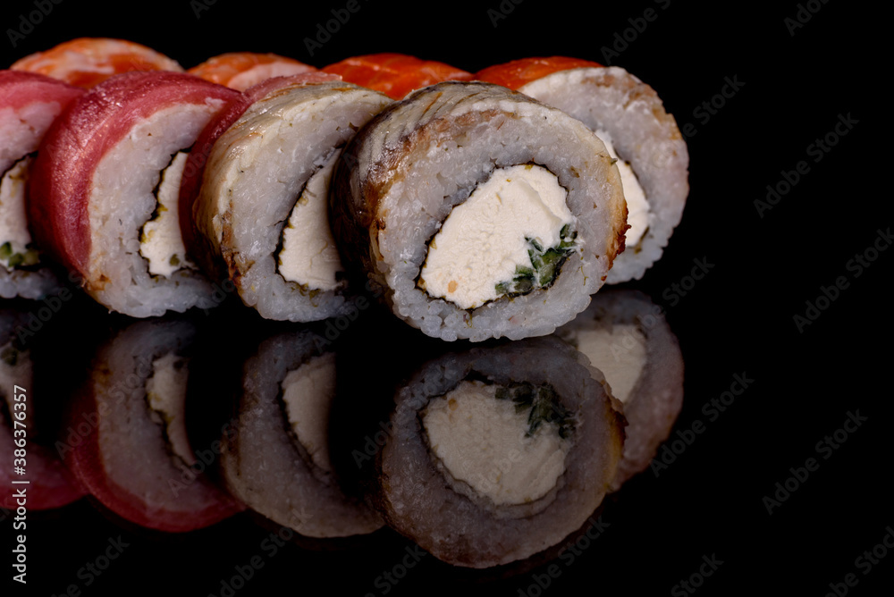 Fresh delicious beautiful sushi rolls on a dark background Fresh delicious beautiful sushi rolls on a dark background
