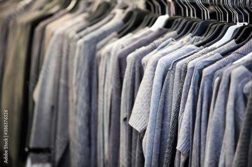 sweaters and clothes on display on a drying rack